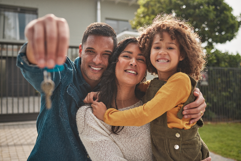 Family holding new keys to home